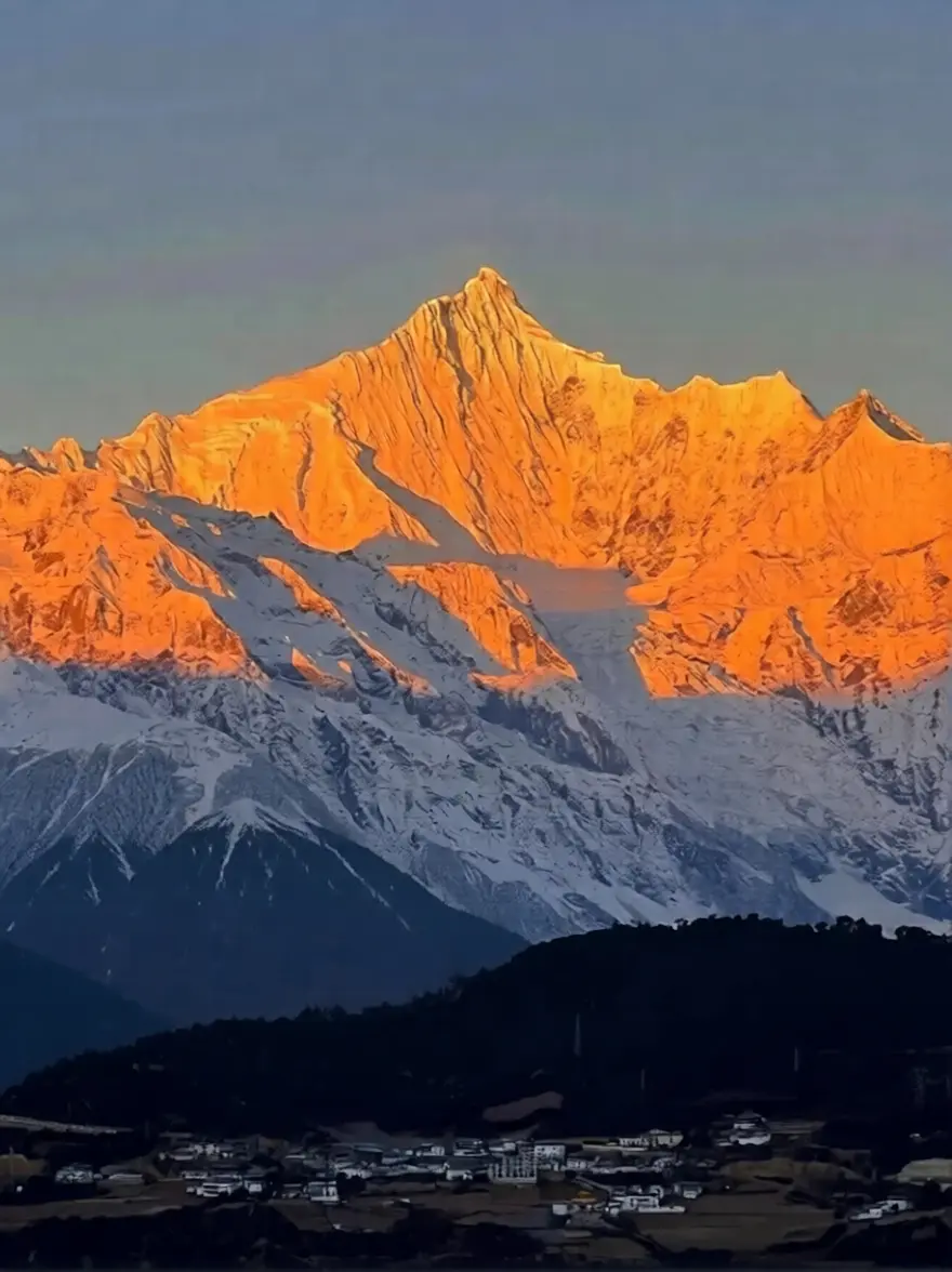 Meili Snow Mountain bathed in golden sunlight