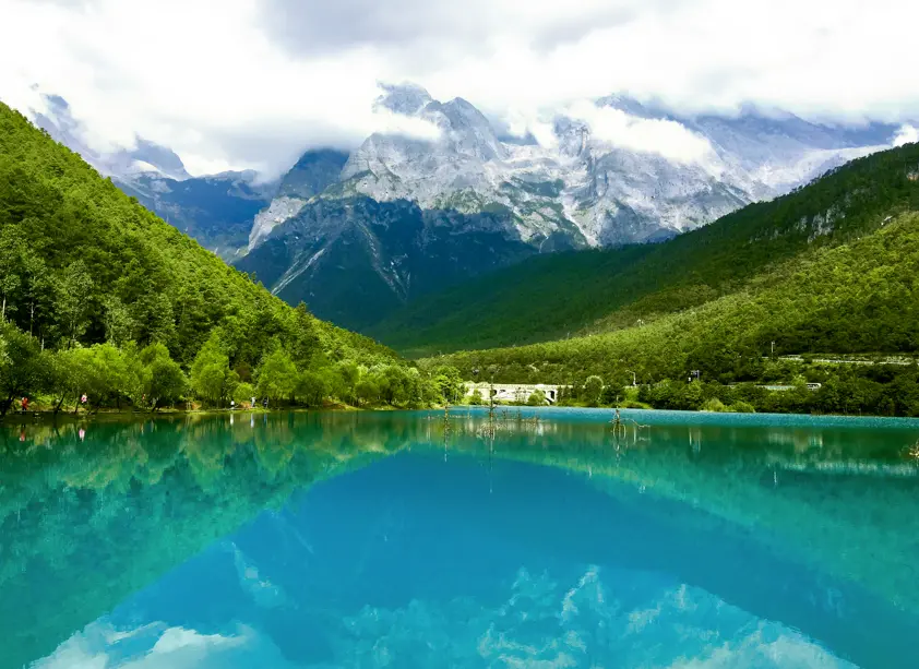 Calm Blue Moon Valley lake mirroring snow-capped mountains