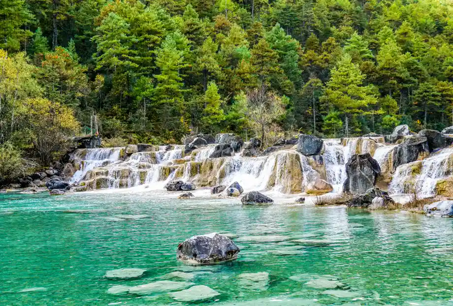 Blue Moon Valley Below Jade Dragon Snow Mountain China:Rocky cascades in Blue Moon Valley’s clear waters