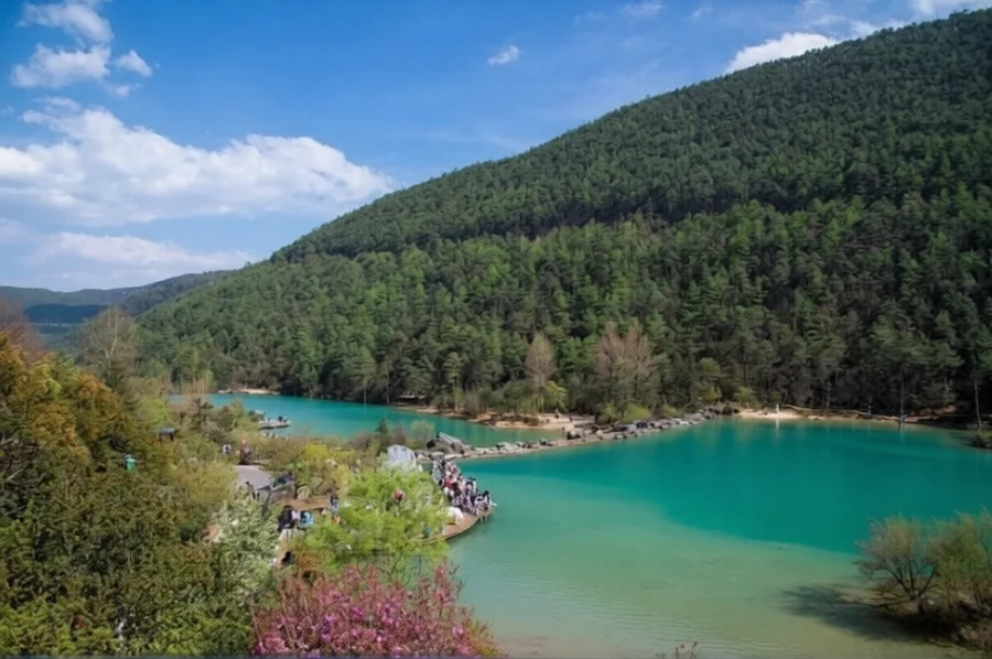 Turquoise lake and forested mountains in Blue Moon Valley, Yunnan