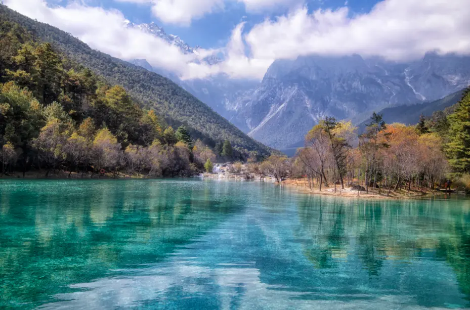 Blue Moon Valley Below Jade Dragon Snow Mountain China:Turquoise lake reflecting Jade Dragon Snow Mountain peaks