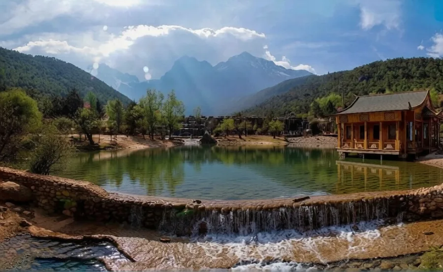 Wooden pavilion and Jade Dragon Snow Mountain at Blue Moon Valley