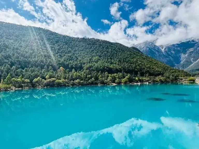 Blue Moon Valley Jade Dragon Snow Mountain reflection in turquoise lake on a sunny day