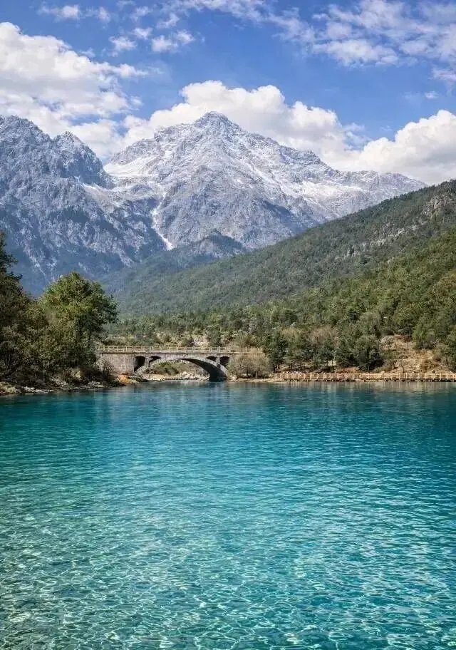 Blue Moon Valley Travel Guide: A Turquoise Fairyland at Jade Dragon Snow Mountain's Foot (Altitude, Weather & How to Get to Blue Moon Valley Lijiang)The emerald green lake and stone arch bridge in Blue Moon Valley, Yunnan, China