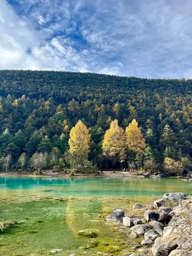 Blue Moon Valley Yunnan in autumn with turquoise water and golden trees