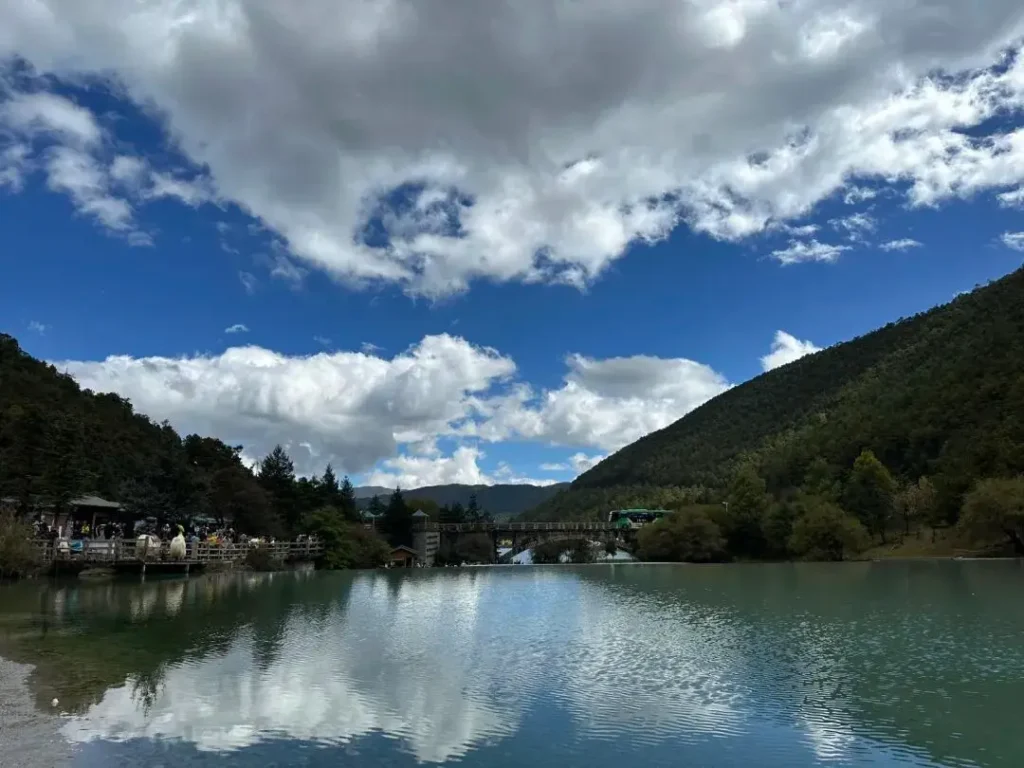 Stone arch bridge at Blue Moon Lake with Jade Dragon Snow Mountain view